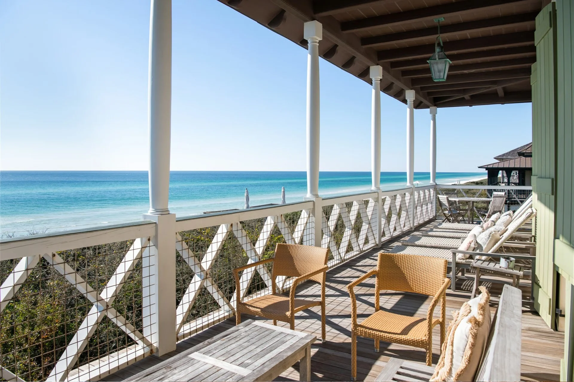 Balcony with outdoor furniture overlooking the ocean.